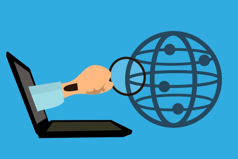 Flattened illustration depicting an arm coming out of a laptop screen while holding a magnifying glass that is pointed to a stylized globe.
